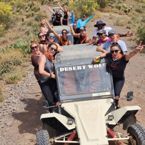 a man riding a motorcycle down a dirt road