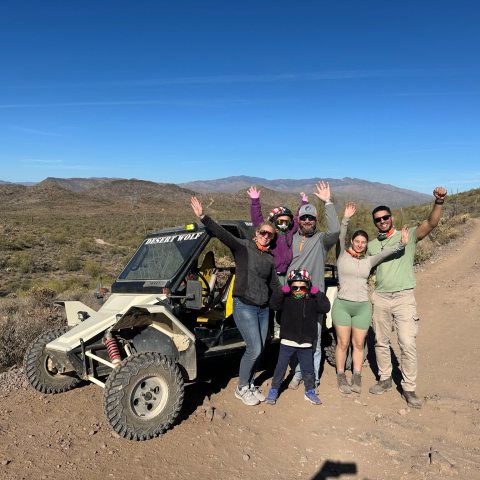 Group of friends navigating a Tomcar on a Scottsdale/Phoenix Sonoran Desert ATV adventure with Desert Wolf Tours — no helmets or goggles.
